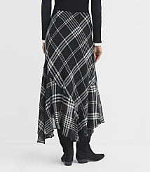 A person wearing a black and white plaid skirt and black boots stands against a plain white background. carousel Product Image 4