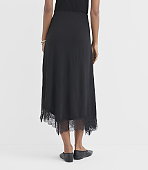 A woman in a black lace-trimmed skirt stands against a plain white background. carousel Product Image 3