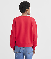 A woman in a red sweatshirt and blue jeans stands against a plain white background. carousel Product Image 3
