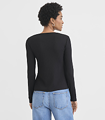 A woman in a black ribbed long-sleeved shirt and blue jeans stands against a plain white background. carousel Product Image 3