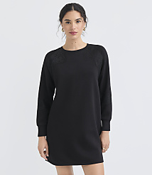 A woman in a black dress stands against a plain white background. carousel Product Image 2