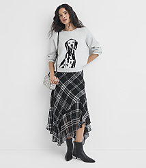 A woman in a Dalmatian-print sweatshirt and plaid skirt stands against a plain white background. carousel Product Image 2