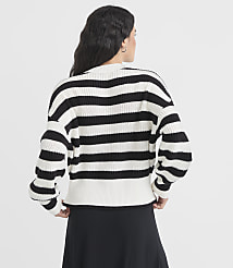 A woman in a black and white striped sweater stands against a plain white background. carousel Product Image 3