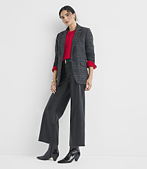 A woman in a plaid blazer, red sweater, and black leather pants stands against a plain white background. carousel Product Image 2