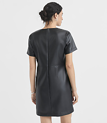 A woman in a black faux leather dress stands against a plain white background. carousel Product Image 3