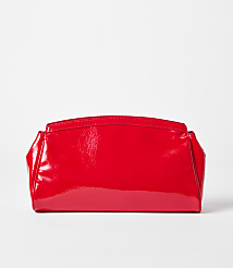 A shiny red clutch rests on a white surface against a plain white background. carousel Product Image 1