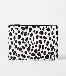 A black and white spotted clutch rests on a plain white background. carousel Product Image 1