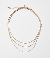 A delicate rose gold layered necklace with a white background. carousel Product Image 1