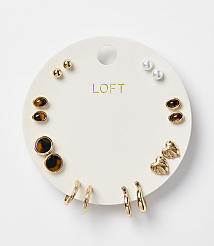 A white circular card displays a collection of gold and pearl earrings, with the "LOFT" logo in gold lettering at the top, against a plain white background. carousel Product Image 1