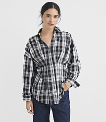A woman in a plaid shirt and jeans stands against a plain white background. carousel Product Image 2