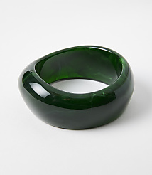 A glossy, dark green, irregularly shaped bangle rests on a plain white background. carousel Product Image 1