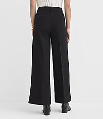 A person wearing black wide-leg pants and black boots stands against a plain white background. carousel Product Image 3