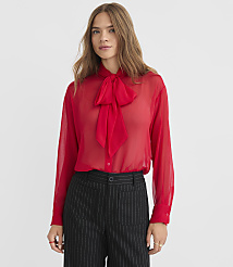 A woman in a red sheer blouse and pinstripe pants stands against a plain white background. carousel Product Image 1