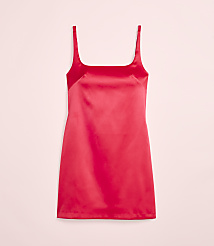 A vibrant red satin slip dress hangs against a soft pink background. carousel Product Image 2