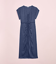 A navy blue ruched midi dress is laid flat against a soft pink background. carousel Product Image 4