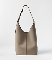 A taupe leather hobo bag with a single strap stands against a plain white background. carousel Product Image 1