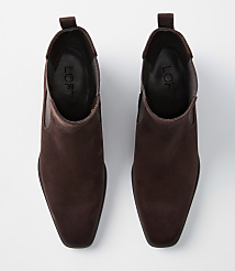 A pair of brown suede Chelsea boots with square toes are laid out on a plain white background. carousel Product Image 3