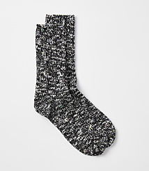 A pair of speckled black and white socks rests on a plain white background. carousel Product Image 1