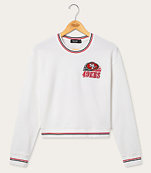 A white San Francisco 49ers sweatshirt with striped cuffs and neckline hangs on a wooden hanger against a plain white background. carousel Product Image 1