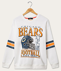 A white Chicago Bears sweatshirt with striped sleeves hangs on a wooden hanger against a plain white background. carousel Product Image 1