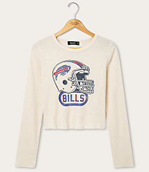 A cream-colored long-sleeved shirt with a vintage Buffalo Bills helmet graphic is displayed on a wooden hanger against a white background. carousel Product Image 1