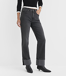 A person in dark wash cuffed jeans and black boots stands against a plain white background. carousel Product Image 2