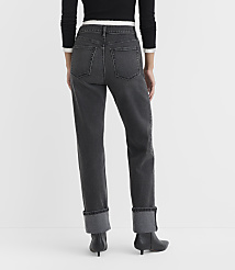 A person wearing dark wash cuffed jeans and black heeled boots stands against a plain white background. carousel Product Image 3