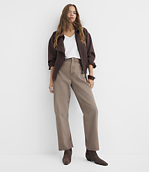 A woman in a brown jacket and taupe pants stands against a plain white background. carousel Product Image 2