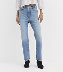 A person wearing light-wash denim jeans and black ankle boots stands against a plain white background. carousel Product Image 2