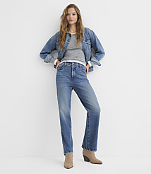 A woman in a denim jacket and jeans stands against a plain white background. carousel Product Image 1