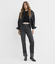A woman in a black leather jacket and dark jeans stands against a plain white background. carousel Product Image 1