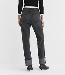 A person wearing cuffed dark wash jeans and black boots stands against a plain white background. carousel Product Image 2