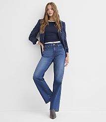 A woman in a navy pinstripe blazer and blue jeans stands against a plain white background. carousel Product Image 1
