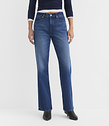 A person wearing dark blue jeans and a navy top stands against a plain white background. carousel Product Image 2