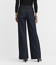 A person wearing dark wash wide-leg jeans and black heels stands against a plain white background. carousel Product Image 3
