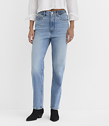 A person wearing light-wash jeans and black boots stands against a plain white background. carousel Product Image 1