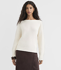 A woman in a cream-colored boatneck sweater and brown skirt stands against a plain white background. carousel Product Image 1