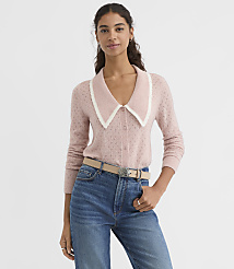 A woman in a pink cardigan with a white collar stands against a plain white background. carousel Product Image 1