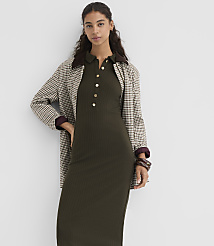 A woman in a ribbed olive green dress and a plaid jacket stands against a plain white background. carousel Product Image 2