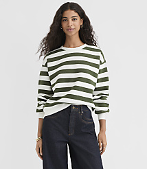 A woman in a green and white striped sweatshirt and dark jeans stands against a plain white background. carousel Product Image 1