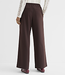 A person wearing brown wide-leg pants and a white lace top stands against a plain white background. carousel Product Image 3