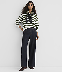 A woman in a striped sweater and wide-leg jeans stands against a plain white background. carousel Product Image 2