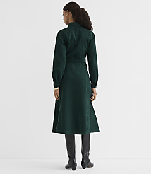A woman in a green corduroy dress and black boots stands against a plain white background. carousel Product Image 3