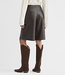 A person wearing brown faux leather culottes and brown suede boots stands against a plain white background. carousel Product Image 3