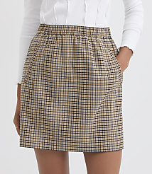 A person in a white top and a plaid skirt with pockets stands against a plain white background. carousel Product Image 2