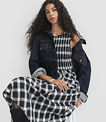 A woman in a black and white checkered dress stands against a plain white background. carousel Product Image 2