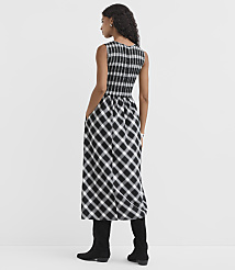A woman in a black and white checkered dress stands against a plain white background. carousel Product Image 3