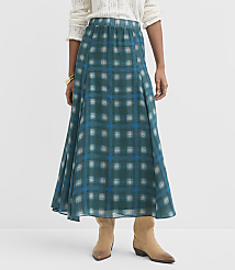A woman in a teal plaid maxi skirt and tan boots stands against a plain white background. carousel Product Image 2