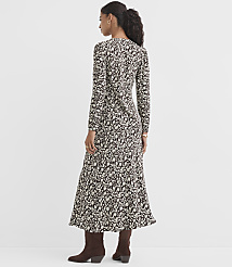 A woman in a long-sleeved, floral-print dress and brown boots stands against a plain, light gray background. carousel Product Image 3