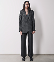 A woman in a plaid blazer and black leather pants stands against a plain white background. carousel Product Image 4
